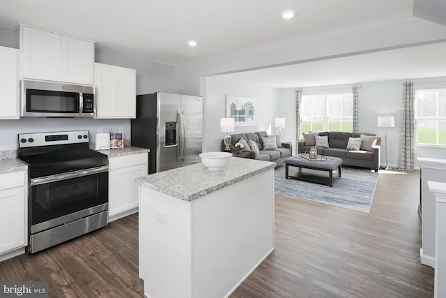 kitchen featuring white cabinets, a healthy amount of sunlight, and stainless steel appliances