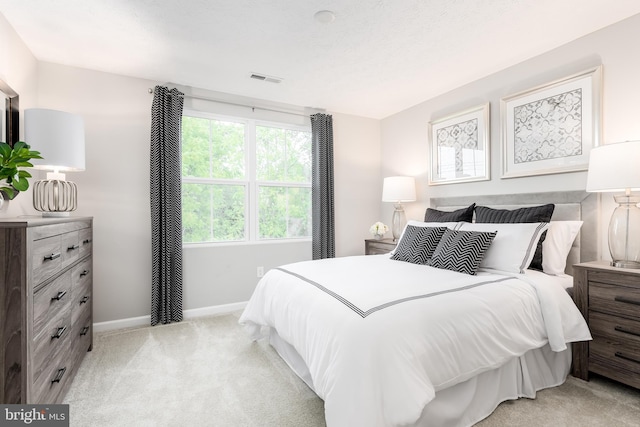 bedroom with light colored carpet