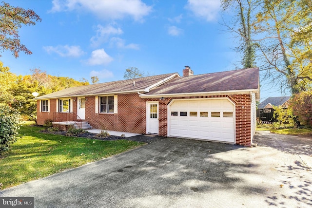 ranch-style house with a front yard and a garage