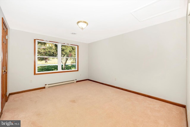 empty room with a baseboard heating unit and light colored carpet