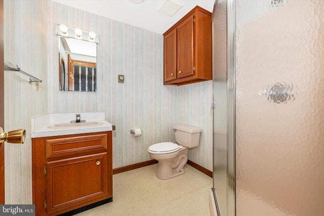 bathroom featuring vanity, toilet, and walk in shower