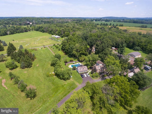 drone / aerial view featuring a forest view