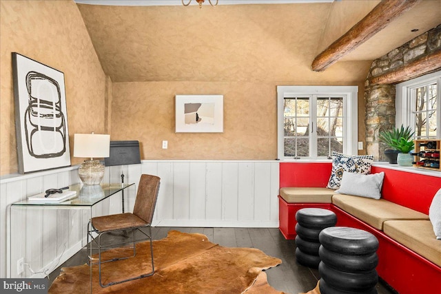 interior space with beamed ceiling, dark wood-type flooring, and wainscoting