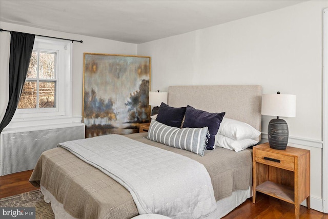 bedroom featuring dark wood-style flooring and radiator