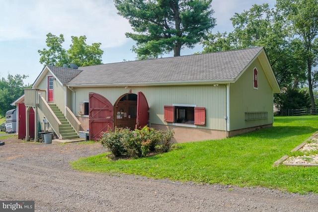 view of front of property with a front yard and stairway