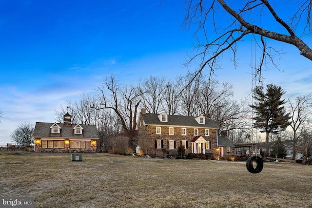 view of front of house featuring a front yard and a chimney