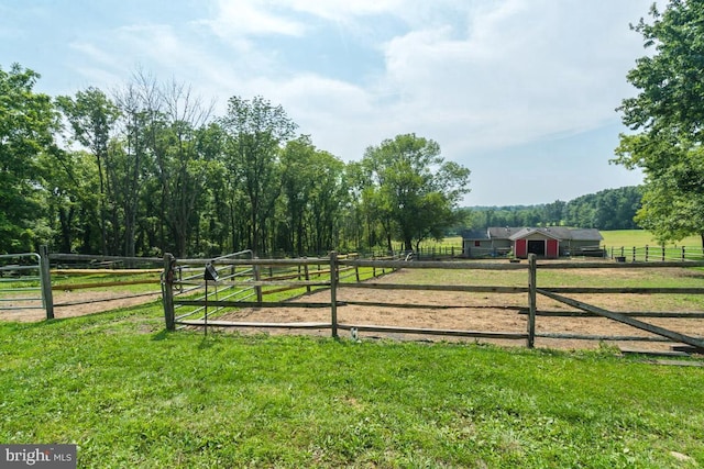 view of yard with an enclosed area and a rural view