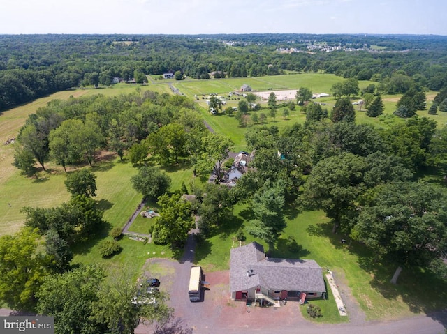 birds eye view of property with a view of trees and a rural view