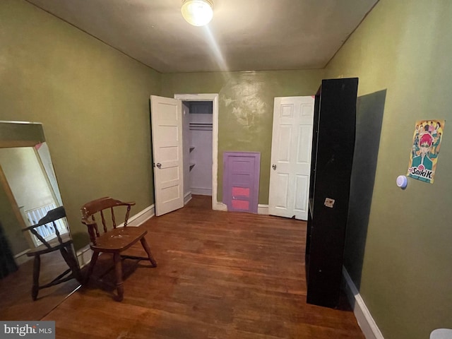 unfurnished room featuring dark wood-type flooring