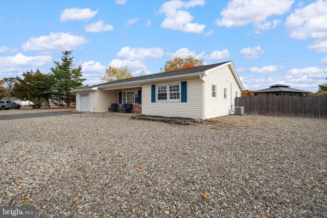 view of front of home with central AC and a garage