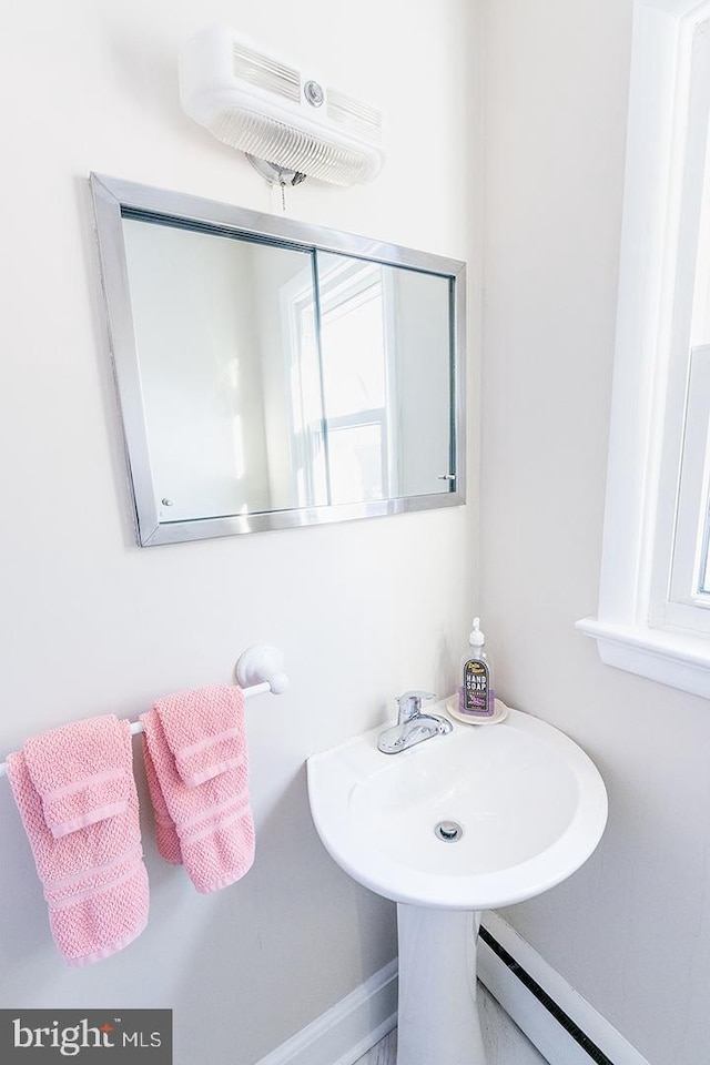 bathroom with a baseboard heating unit