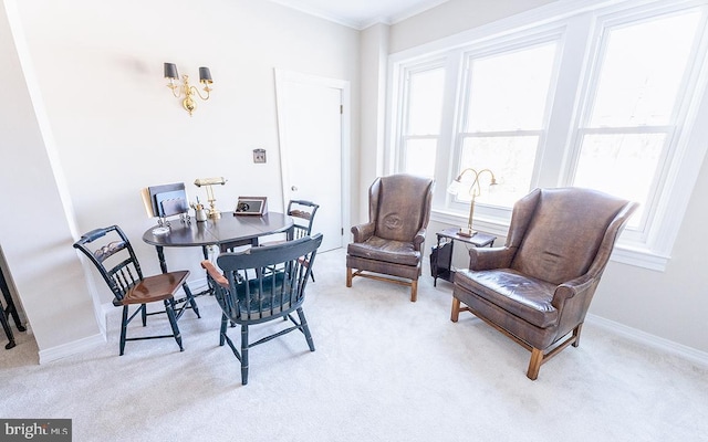 dining area with light colored carpet and ornamental molding