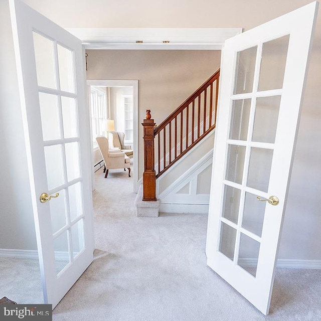 interior space with carpet, french doors, and a baseboard radiator