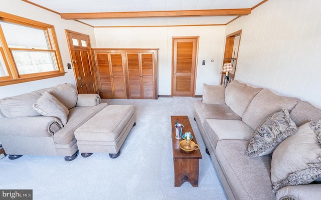 carpeted living room featuring beamed ceiling