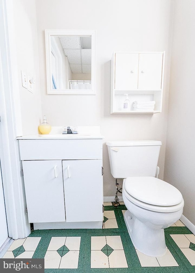 bathroom featuring tile patterned floors, vanity, and toilet