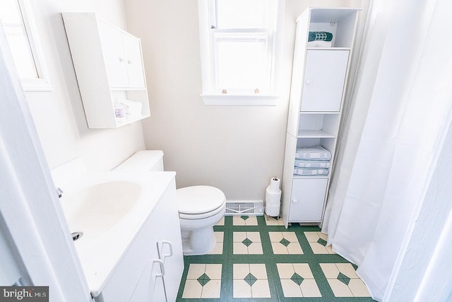 bathroom featuring vanity and toilet