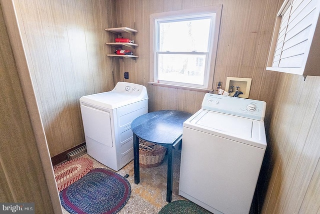 washroom featuring independent washer and dryer and wooden walls