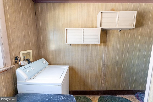 clothes washing area featuring wooden walls and washer / clothes dryer