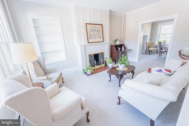 carpeted living room with built in features and crown molding