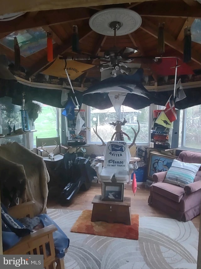 interior space with wood-type flooring, ceiling fan, and vaulted ceiling