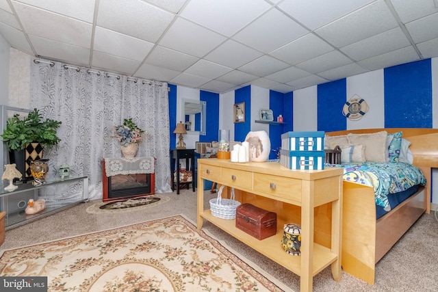 carpeted bedroom featuring a paneled ceiling