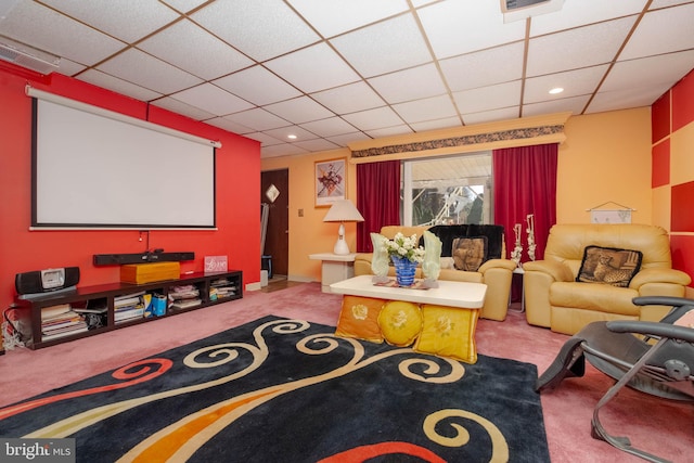 home theater room with a drop ceiling and carpet