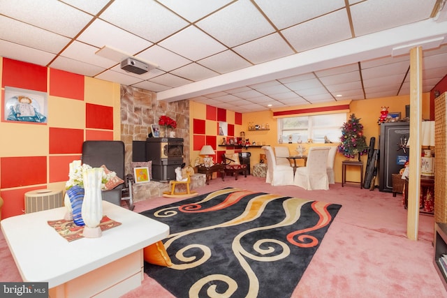 interior space with a paneled ceiling and carpet floors