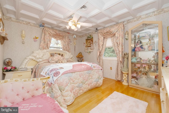 bedroom featuring ceiling fan, wood-type flooring, and multiple windows