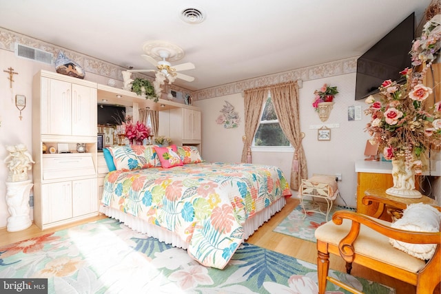 bedroom with light hardwood / wood-style floors and ceiling fan