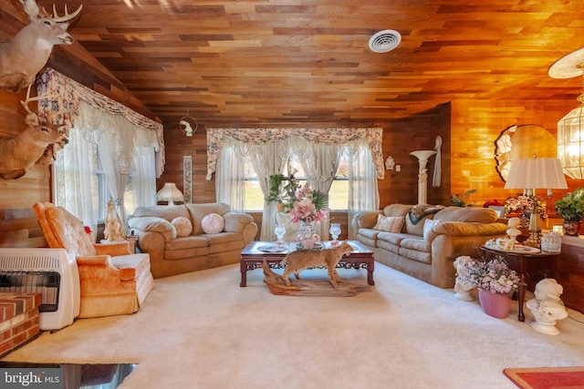 carpeted living room with wooden walls, wood ceiling, and heating unit