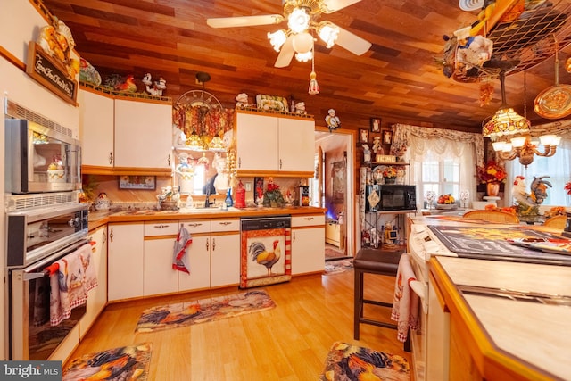 kitchen featuring white cabinets, stainless steel appliances, hanging light fixtures, and wood ceiling