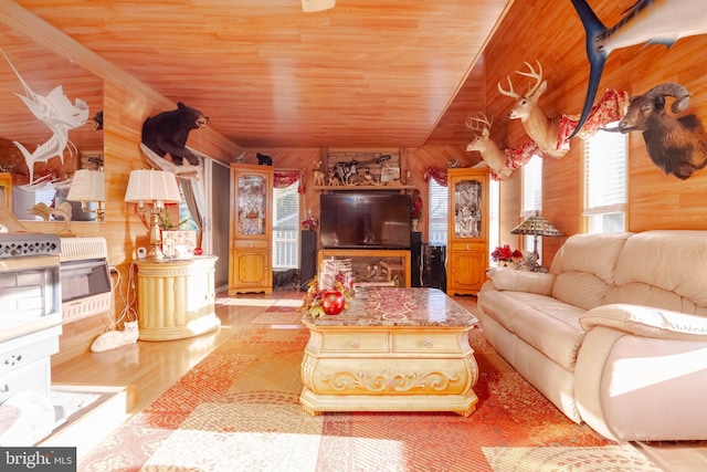 living room featuring heating unit, light wood-type flooring, wooden walls, wood ceiling, and vaulted ceiling