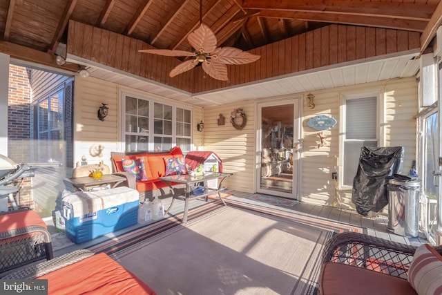 sunroom / solarium with wooden ceiling, ceiling fan, and lofted ceiling with beams