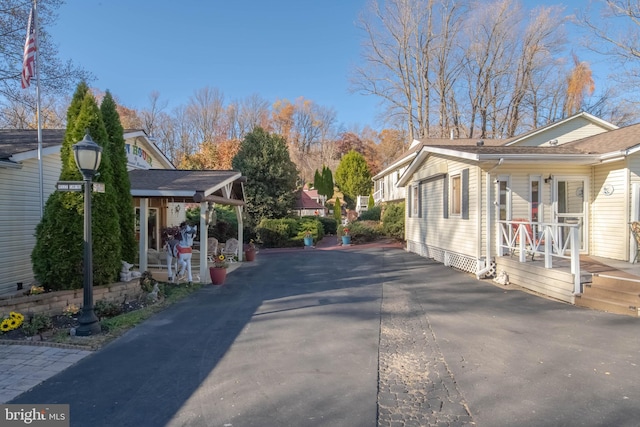 view of side of home featuring covered porch