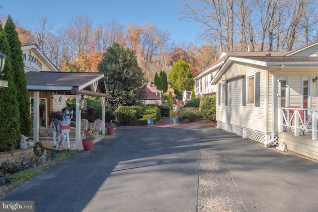 view of side of property with covered porch