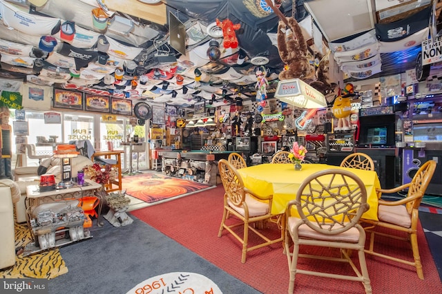 carpeted dining area featuring bar area