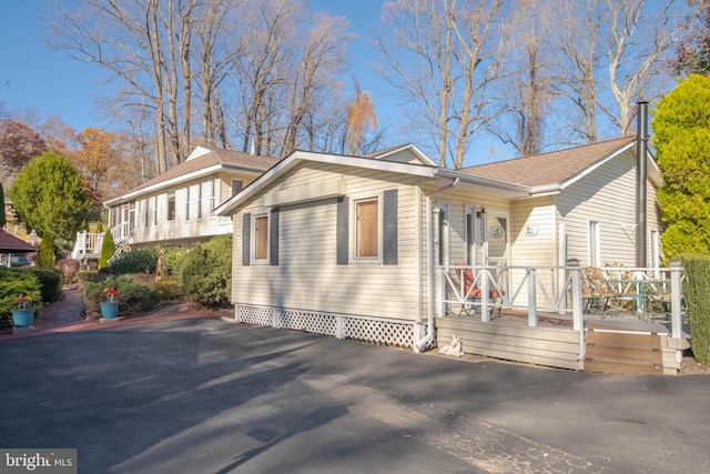 view of property exterior featuring a wooden deck