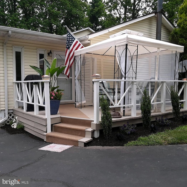 view of exterior entry featuring a porch