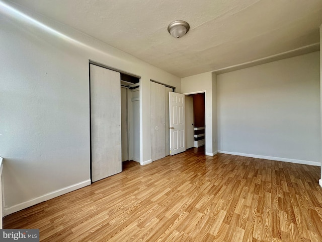 unfurnished bedroom with light wood-type flooring