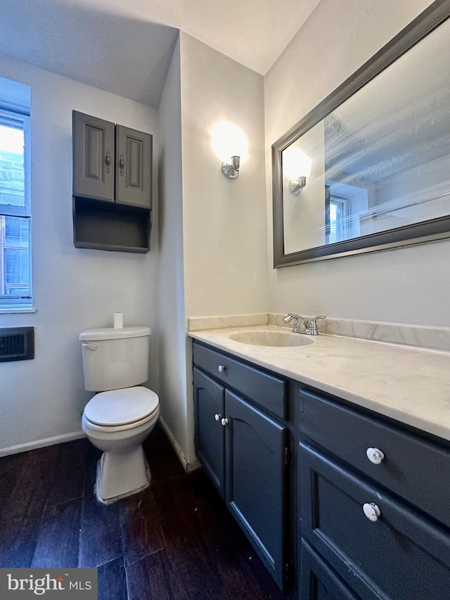 bathroom with vanity, hardwood / wood-style flooring, and toilet