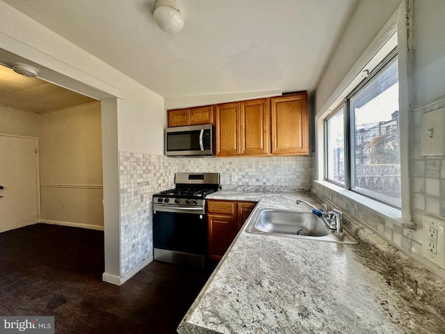 kitchen featuring tasteful backsplash, stainless steel appliances, and sink