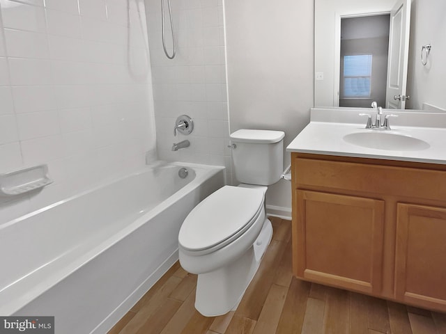 full bathroom with vanity, toilet, tiled shower / bath combo, and wood-type flooring