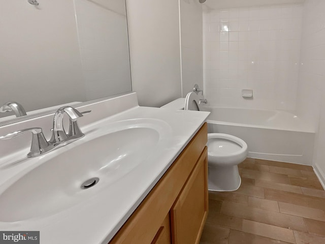 full bathroom with tiled shower / bath, vanity, and toilet