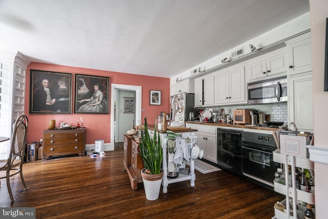 kitchen with white cabinetry, black appliances, and dark hardwood / wood-style floors