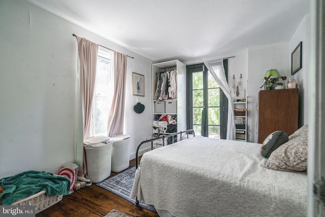 bedroom with dark wood-type flooring