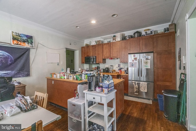 kitchen featuring ornamental molding, dark wood-type flooring, and stainless steel refrigerator