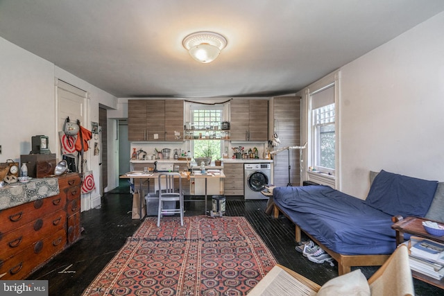 living room featuring washer / dryer and dark hardwood / wood-style flooring