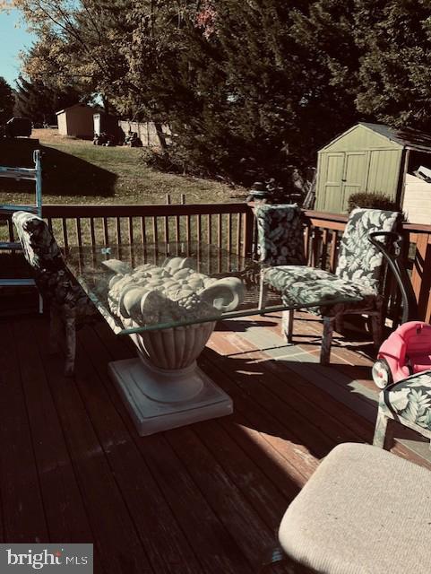 wooden terrace with a shed