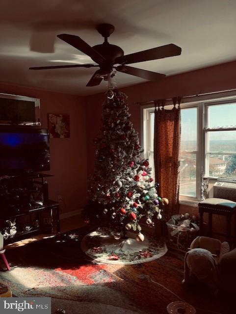 interior space with wood-type flooring and ceiling fan