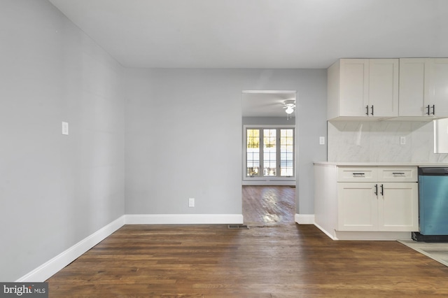 kitchen with white cabinets, tasteful backsplash, ceiling fan, dark hardwood / wood-style flooring, and stainless steel dishwasher